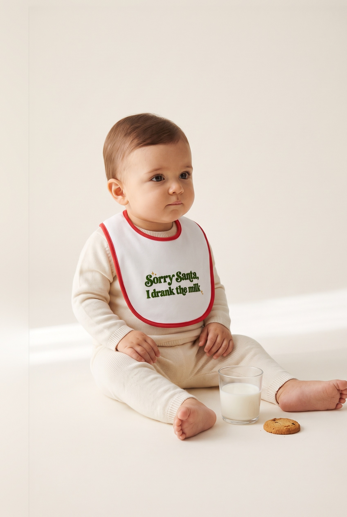 Bavetta neonato bianca con bordino rosso e ricamo verde "Sorry Santa, I drank the milk", foto indossata - Capsule Natale MADRESPERA