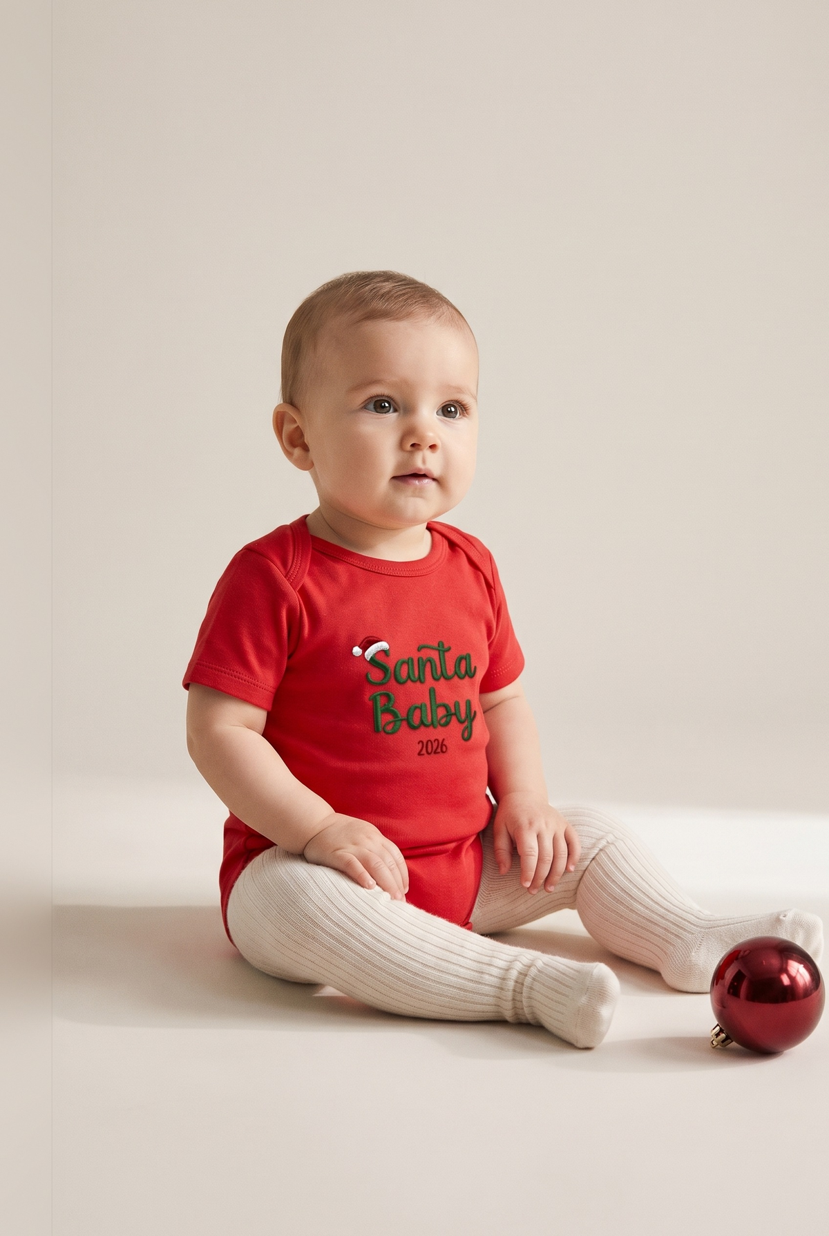 Body neonato rosso con ricamo verde "Santa Baby 2026", foto indossata - Capsule Natale MADRESPERA