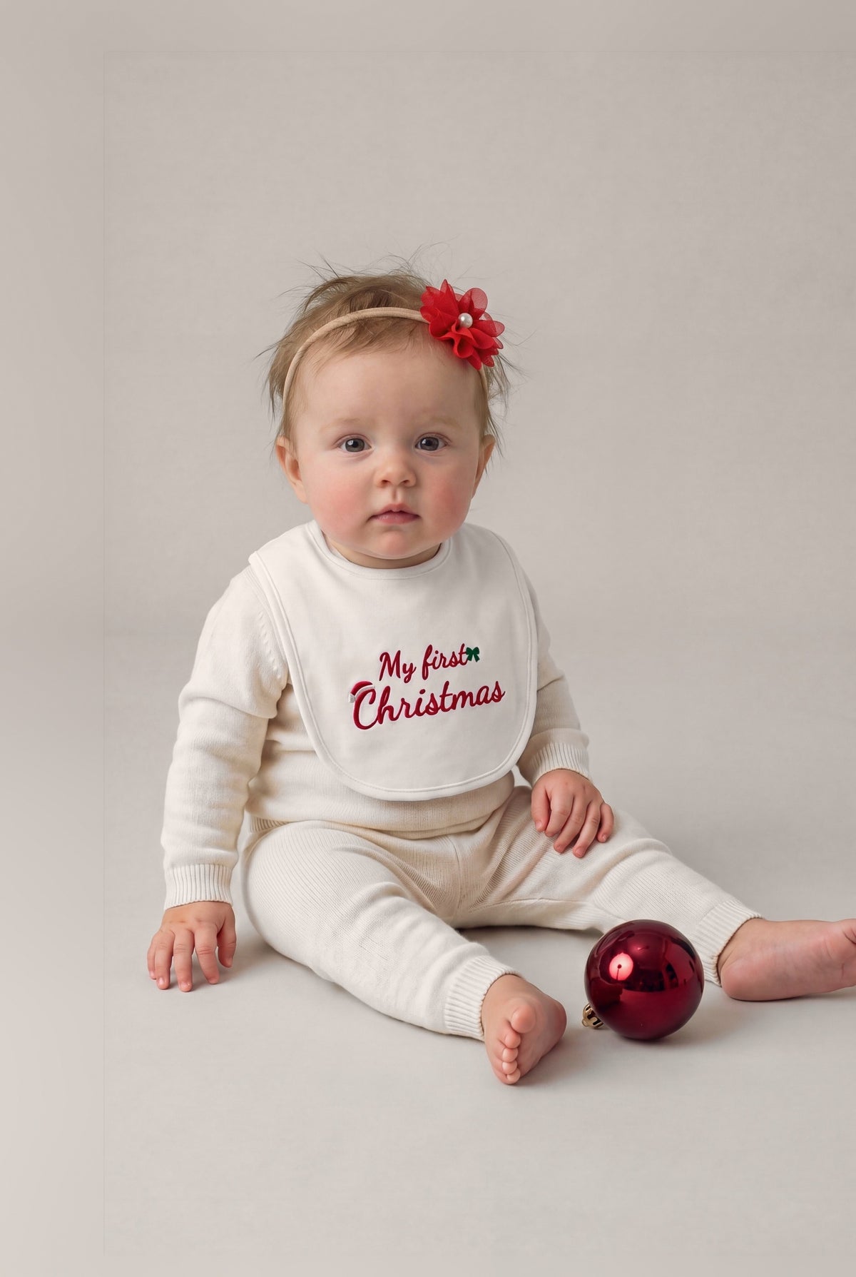 Bavetta ricamata "My first Christmas", foto indossata bimba con fascetta fiore - Capsule Natale MADRESPERA
